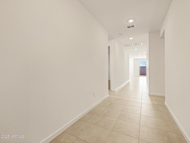 hall featuring light tile patterned floors