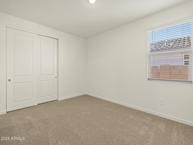 unfurnished bedroom featuring carpet floors and a closet