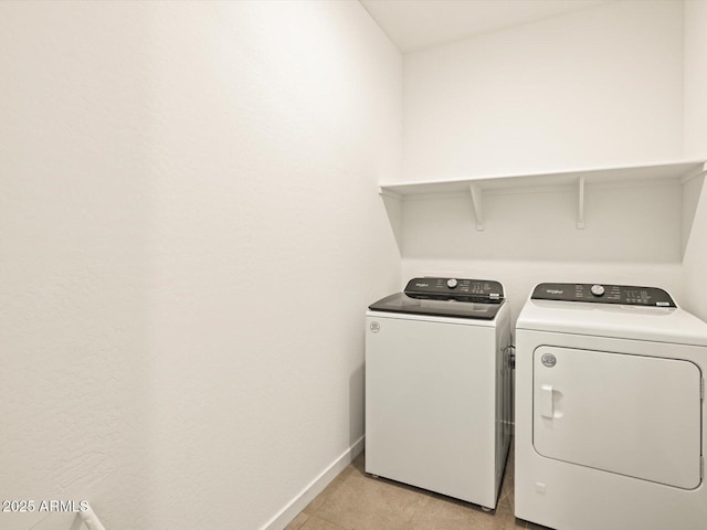 washroom with washing machine and clothes dryer
