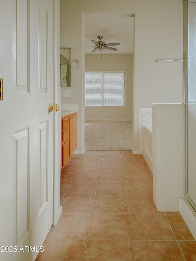 bathroom with ceiling fan, vanity, separate shower and tub, and tile patterned floors