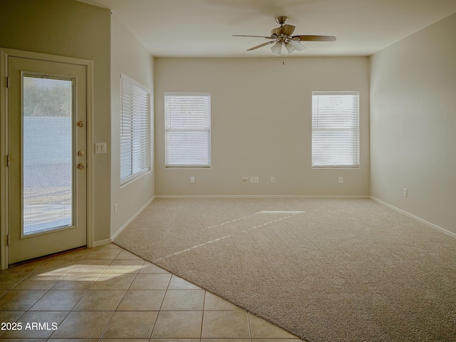 tiled spare room with ceiling fan