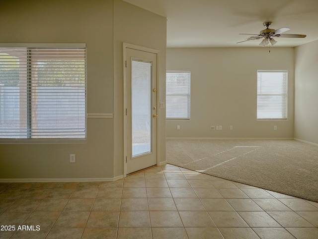 interior space with ceiling fan