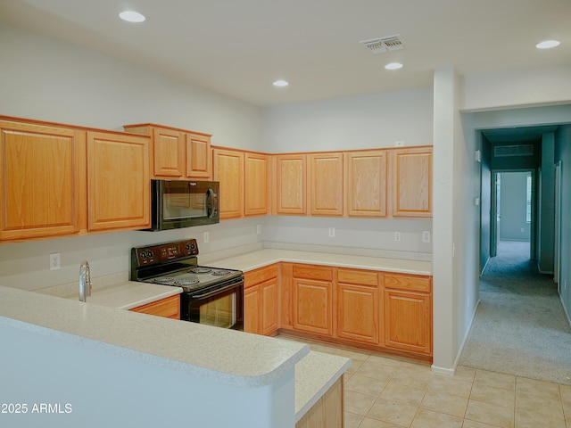 kitchen featuring light brown cabinetry, light colored carpet, kitchen peninsula, and black appliances