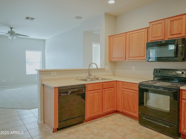 kitchen featuring black appliances, sink, kitchen peninsula, ceiling fan, and light colored carpet