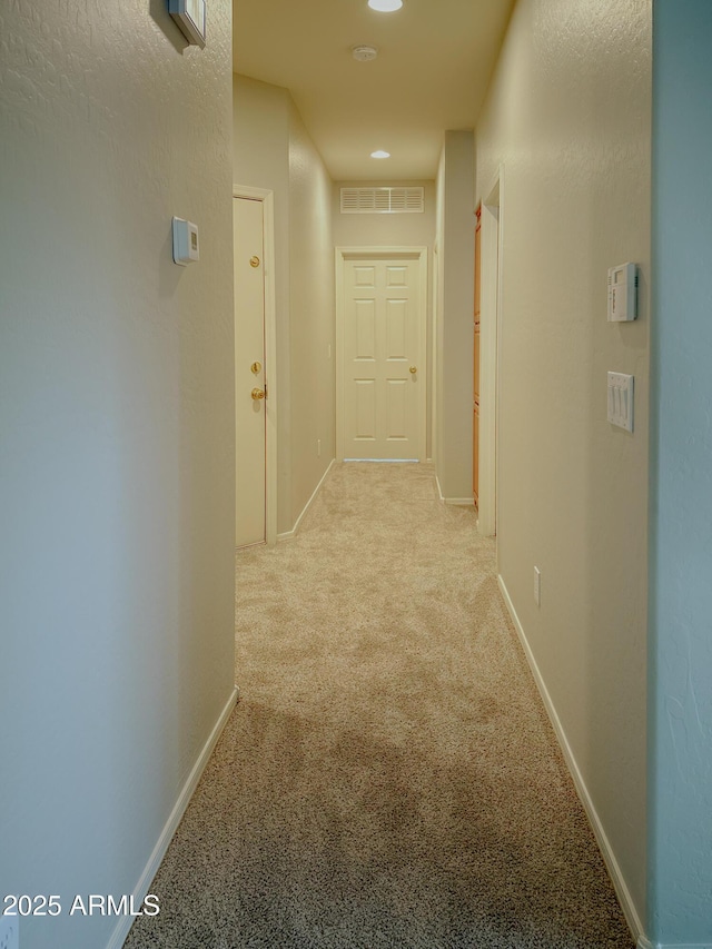 corridor featuring light carpet