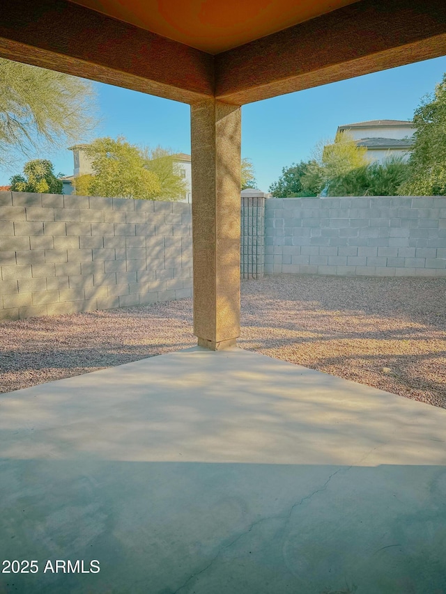 view of gate featuring a patio