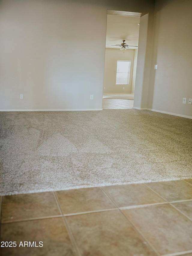 carpeted empty room featuring ceiling fan