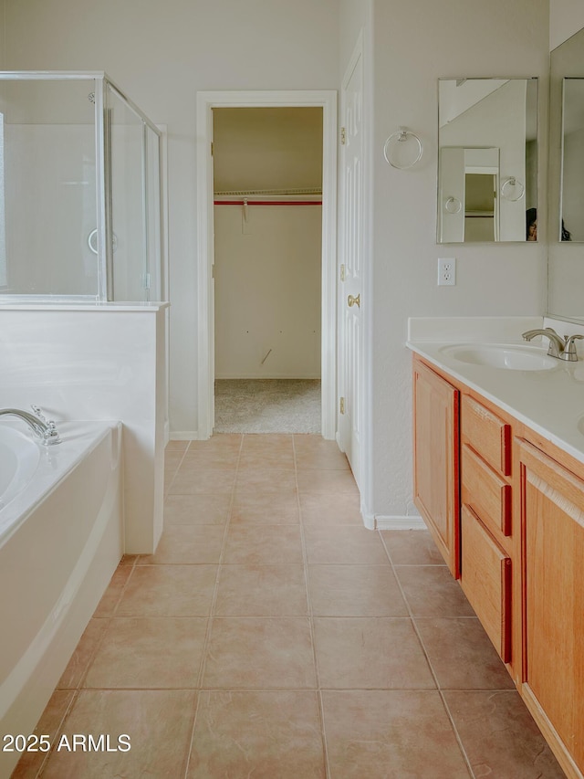 bathroom featuring vanity, tile patterned flooring, and shower with separate bathtub