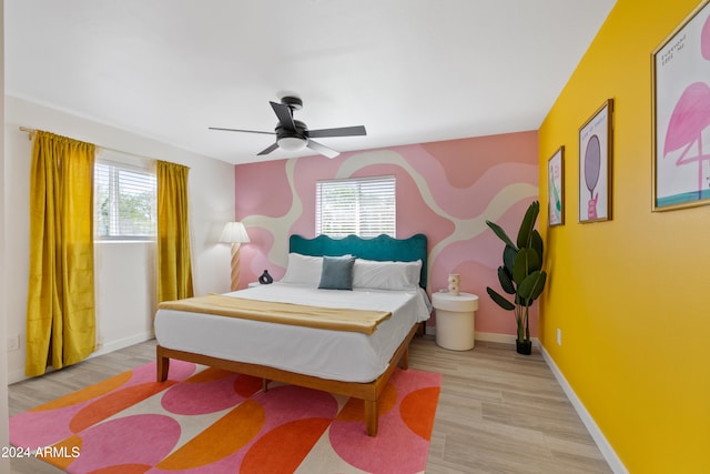 bedroom with light hardwood / wood-style flooring and ceiling fan