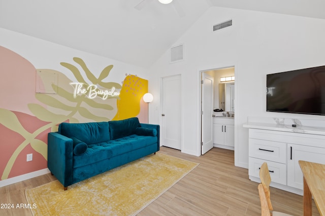 living room featuring high vaulted ceiling, light hardwood / wood-style floors, sink, and ceiling fan