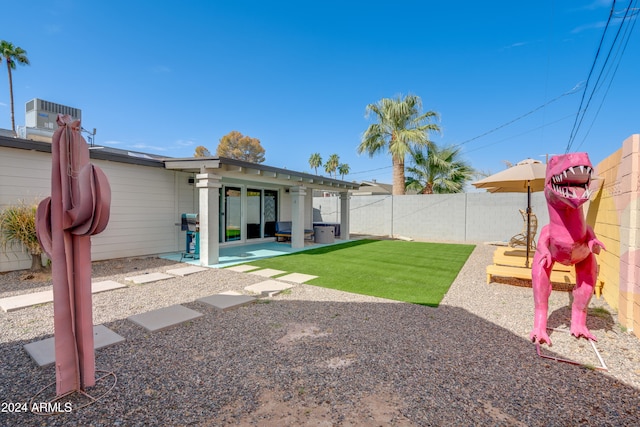 view of yard featuring a patio and central AC unit