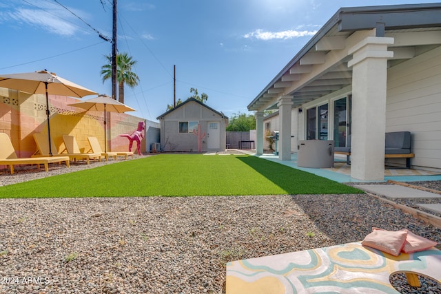 view of yard with an outdoor structure and a patio