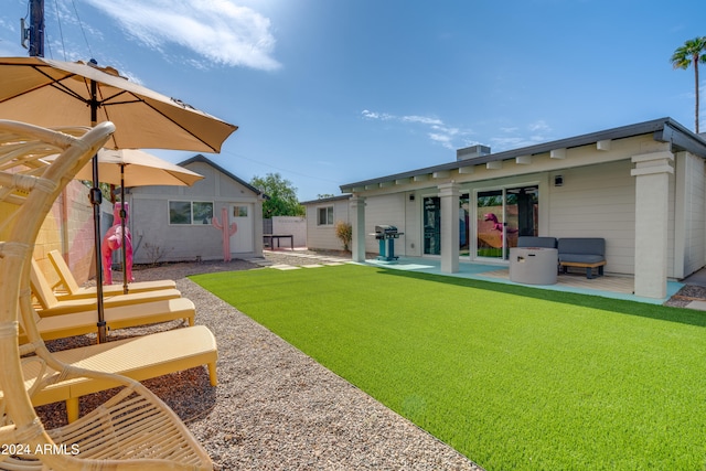 rear view of house featuring a yard and a patio area