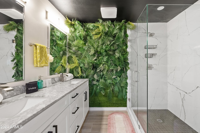 bathroom with vanity and a shower with shower door