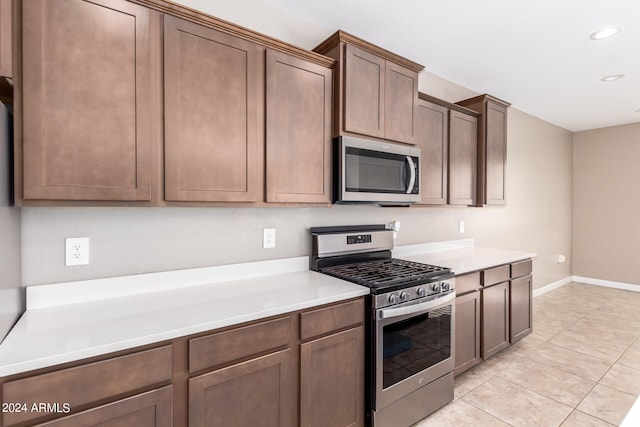 kitchen featuring appliances with stainless steel finishes and light tile patterned flooring