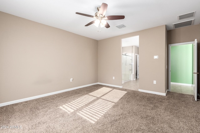 unfurnished bedroom with ceiling fan, connected bathroom, and light carpet