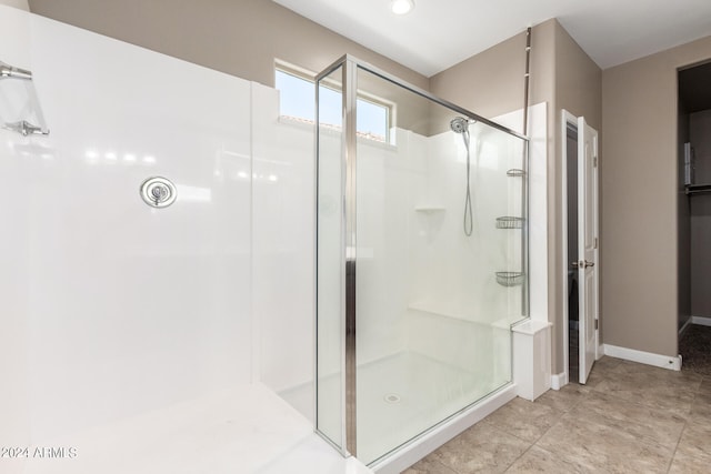 bathroom featuring a shower with door and tile patterned floors