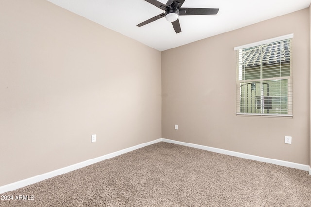 spare room featuring ceiling fan and carpet