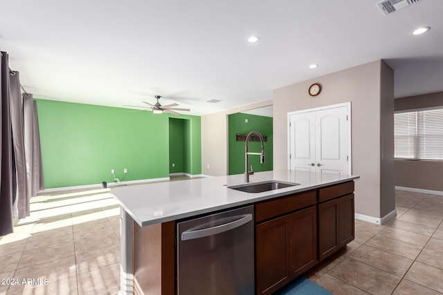 kitchen with an island with sink, ceiling fan, sink, stainless steel dishwasher, and light tile patterned flooring