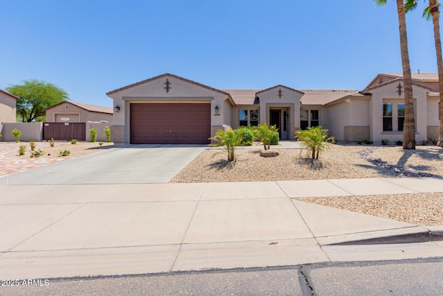 ranch-style house featuring stucco siding, an attached garage, concrete driveway, and fence