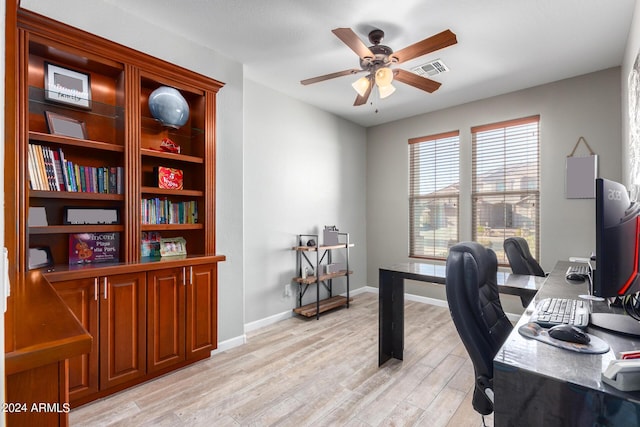 office space featuring ceiling fan, light wood-style flooring, and baseboards
