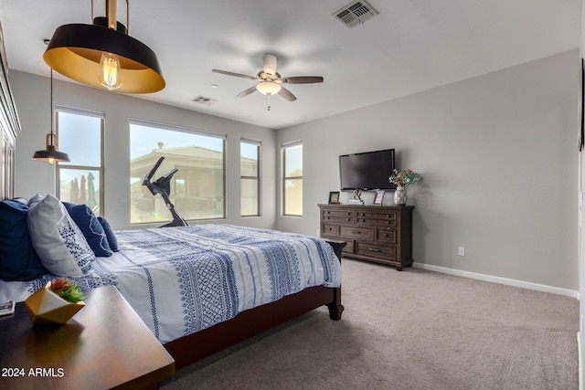 bedroom featuring light carpet, baseboards, and a ceiling fan