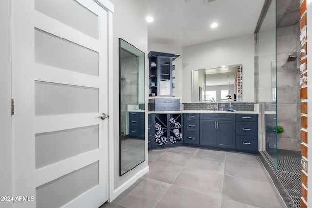 bathroom with a stall shower, vanity, decorative backsplash, tile patterned flooring, and recessed lighting