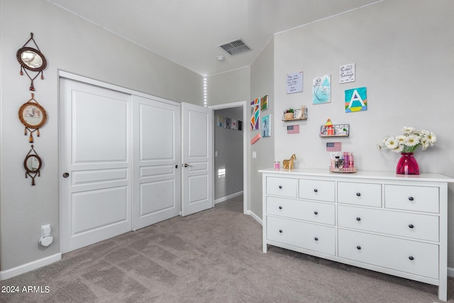 bedroom with carpet, baseboards, and a closet