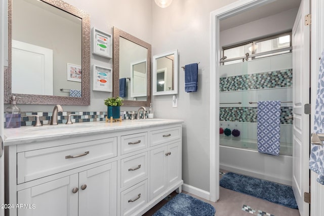 full bathroom featuring enclosed tub / shower combo, double vanity, baseboards, and decorative backsplash