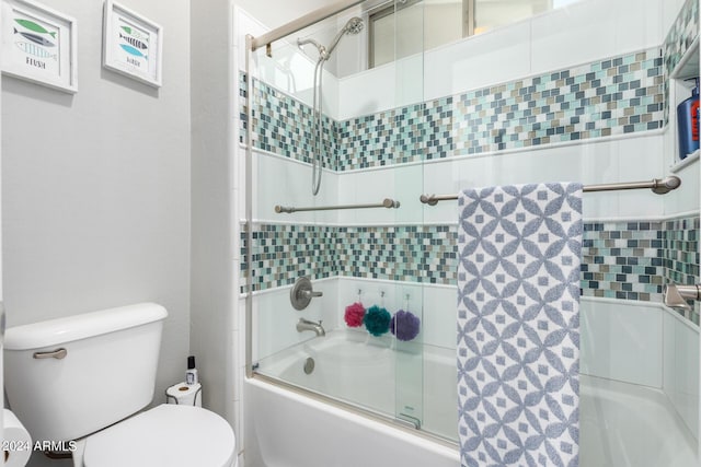 full bath with shower / bath combination with glass door and toilet