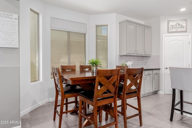 dining room featuring light tile patterned flooring, recessed lighting, and baseboards