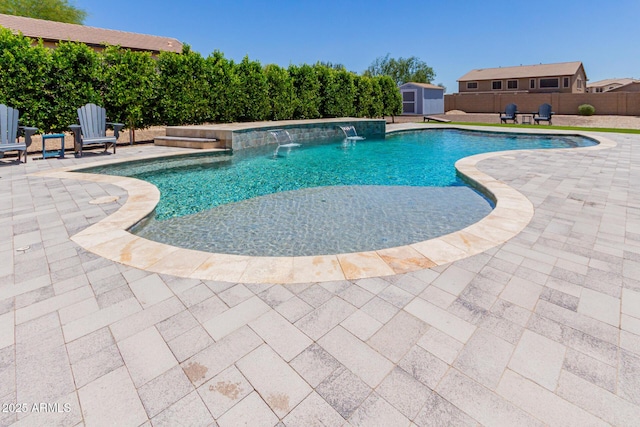 view of pool featuring a patio area, a storage shed, an outdoor structure, and a fenced backyard