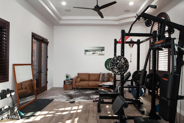 workout area featuring ceiling fan, wood finished floors, and baseboards