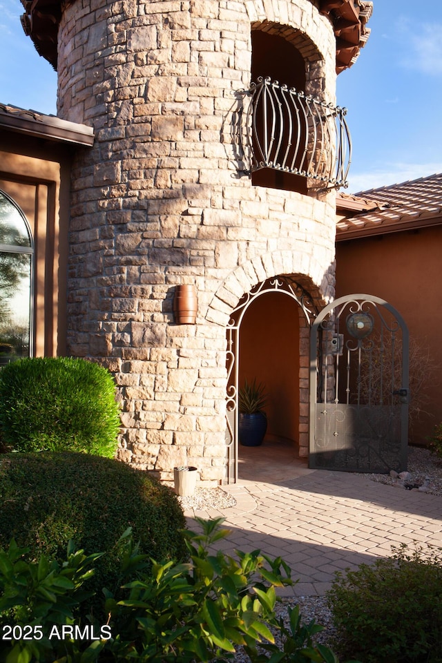 entrance to property with a gate and a fireplace