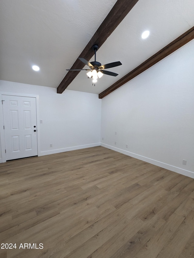 spare room with ceiling fan, beam ceiling, and wood-type flooring