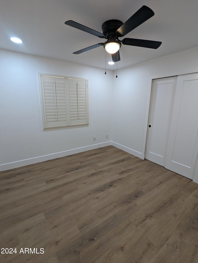 unfurnished room with ceiling fan and dark hardwood / wood-style floors