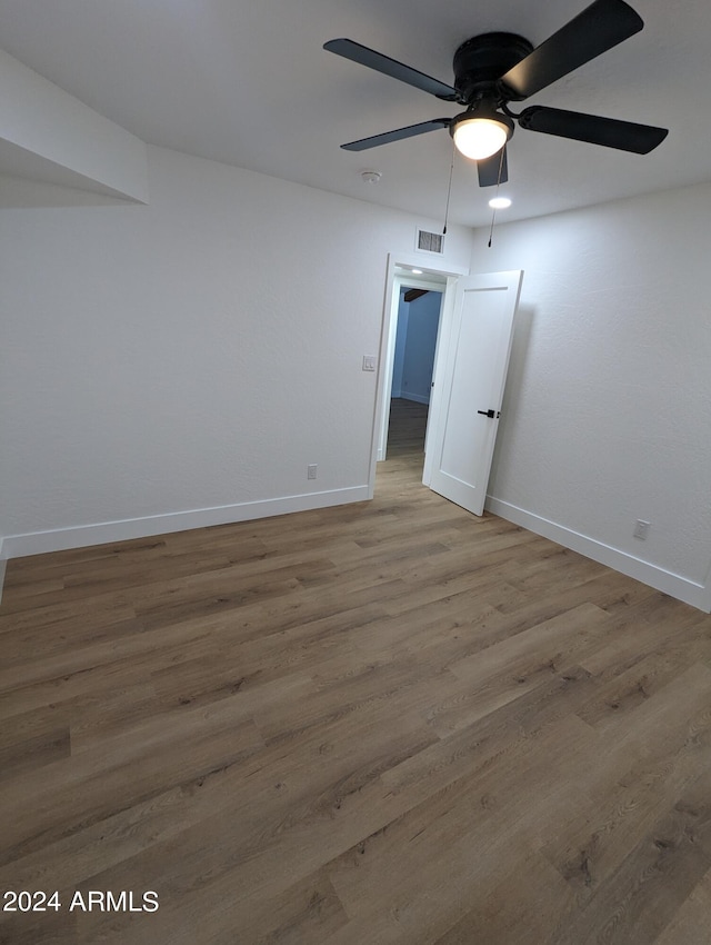 empty room featuring ceiling fan and dark hardwood / wood-style floors