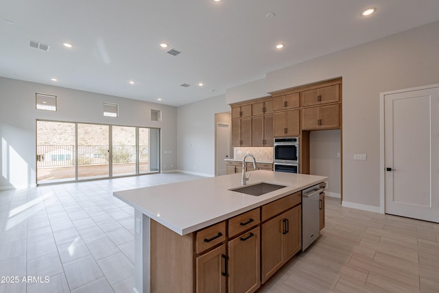 kitchen featuring a center island with sink, stainless steel appliances, and sink