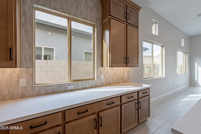 kitchen featuring decorative backsplash and light tile patterned floors