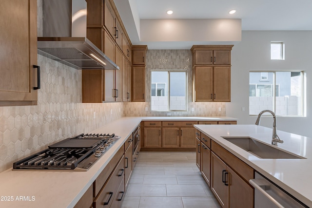 kitchen featuring sink, range hood, backsplash, light tile patterned flooring, and appliances with stainless steel finishes