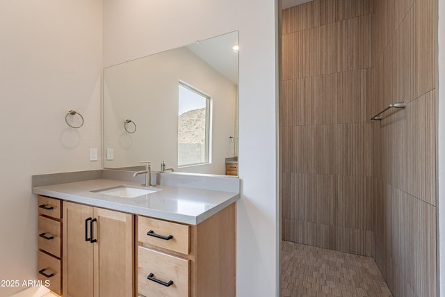 bathroom featuring vanity and tiled shower