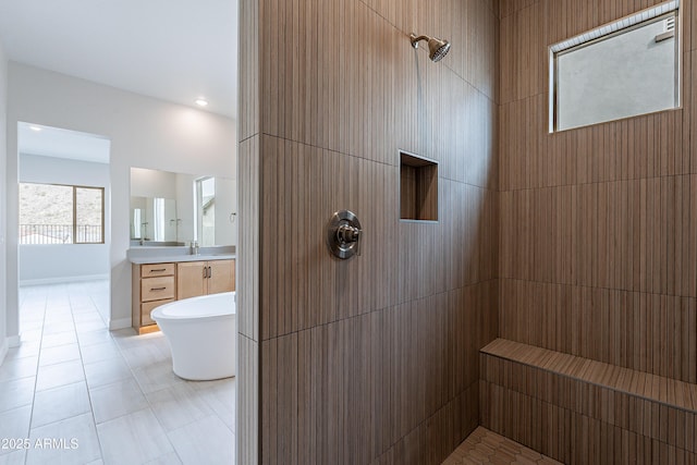 bathroom with tile patterned flooring, vanity, and plus walk in shower