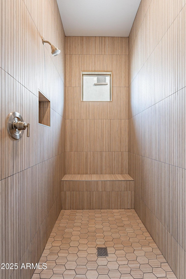 bathroom with a tile shower