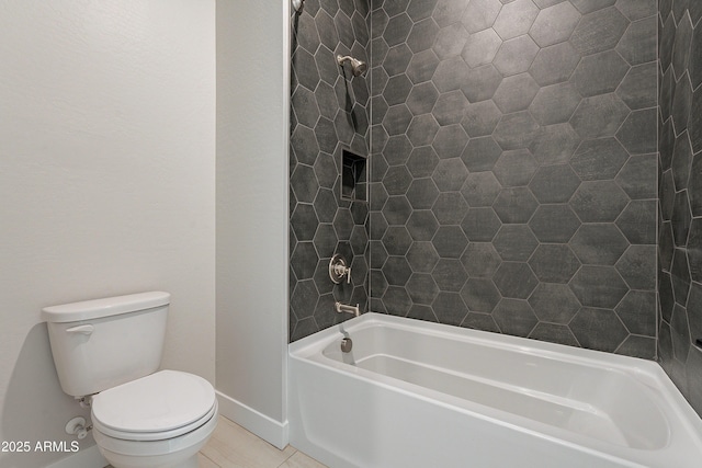 bathroom featuring shower / tub combination, tile patterned floors, and toilet