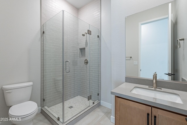 bathroom with tile patterned floors, vanity, toilet, and a shower with door