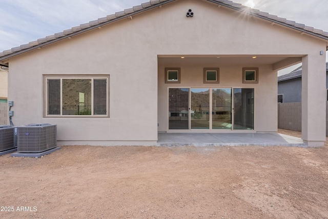 rear view of property featuring a patio and central AC