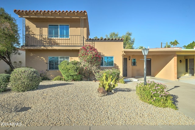 view of front of property with a carport and a balcony