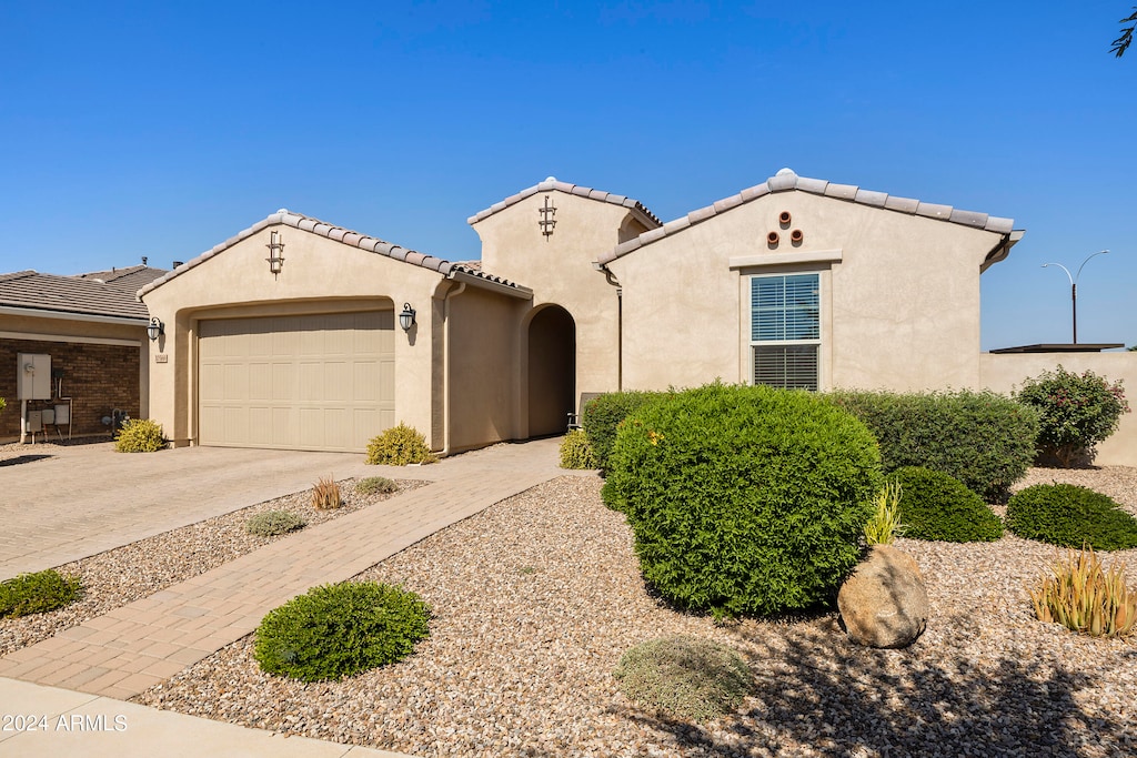 mediterranean / spanish-style house featuring a garage