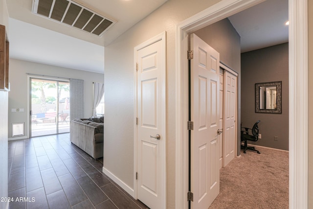 hallway featuring visible vents and baseboards