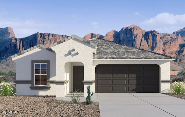 25461 W Graham Trl, Buckeye, AZ 85326 - view of front of property featuring a mountain view, an attached garage, driveway, and stucco siding